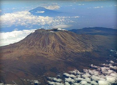 Aerial view of Kilimanjaro's Kibo summit with Mount Meru behind the clouds