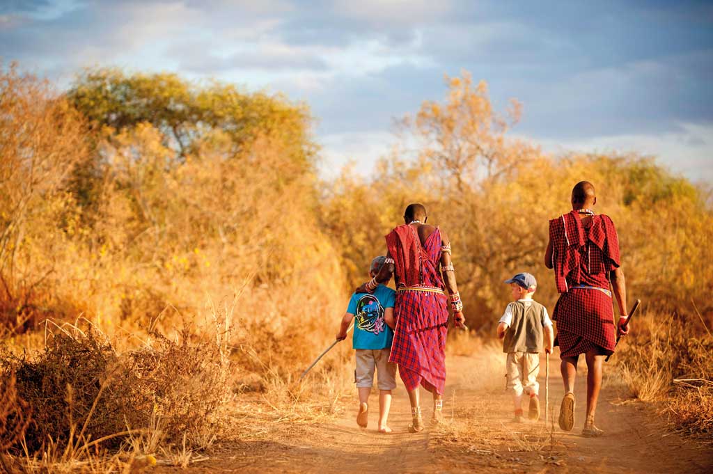 Two children on a guided bush walk with Maasai guides in Kenya